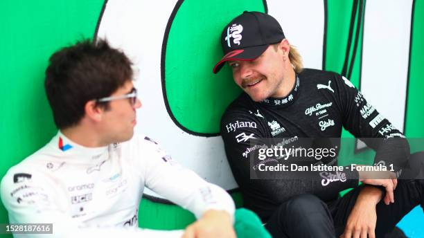 Valtteri Bottas of Finland and Alfa Romeo F1 talks with Lance Stroll of Canada and Aston Martin F1 Team on the grid prior to the F1 Grand Prix of...