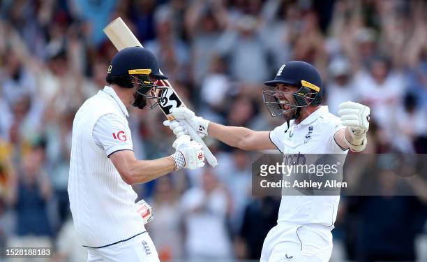 Chris Woakes of England celebrates with teammate Mark Wood after hitting the winning runs to win the LV= Insurance Ashes 3rd Test Match between...