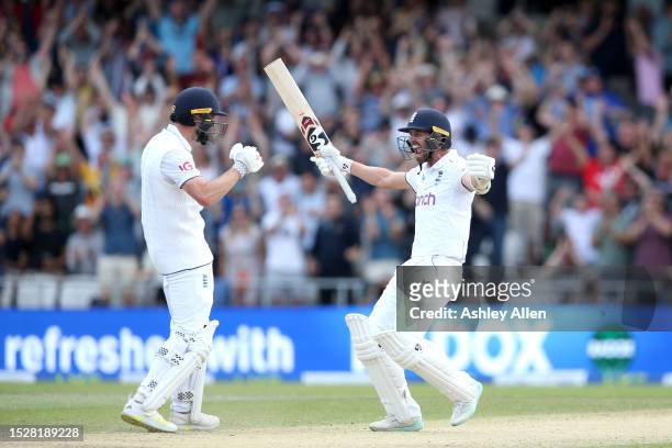 Chris Woakes of England celebrates with teammate Mark Wood after hitting the winning runs to win the LV= Insurance Ashes 3rd Test Match between...