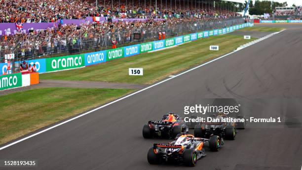 Max Verstappen of the Netherlands driving the Oracle Red Bull Racing RB19, Lando Norris of Great Britain driving the McLaren MCL60 Mercedes and Oscar...