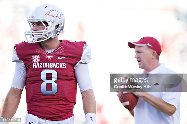 Tyler Wilson and quarterback coach Paul Petrino of the Arkansas Razorbacks on the field before a game against the Rutgers Scarlet Knights at...