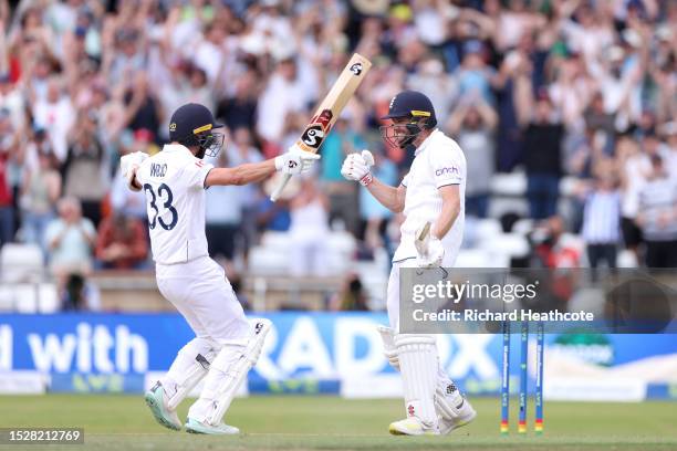 Chris Woakes of England celebrates with teammate Mark Wood after hitting the winning runs to win the LV= Insurance Ashes 3rd Test Match between...