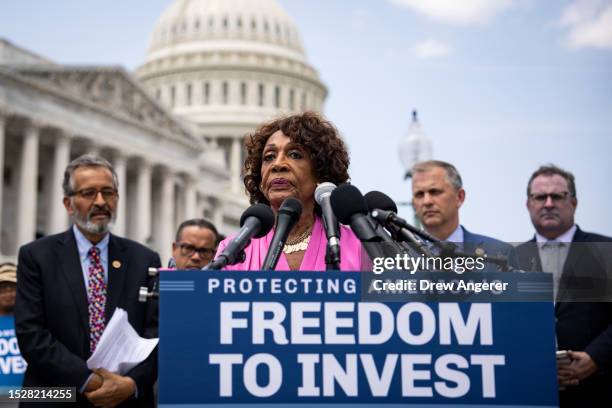 At center, Rep. Maxine Waters speaks during a news conference with Democratic members of the House Financial Services Committee and the Sustainable...