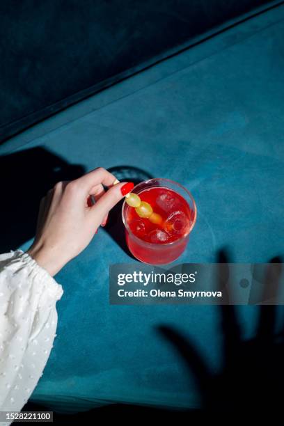 young woman is holding a beautiful cocktail. mixology concept - champagne cocktail stock pictures, royalty-free photos & images