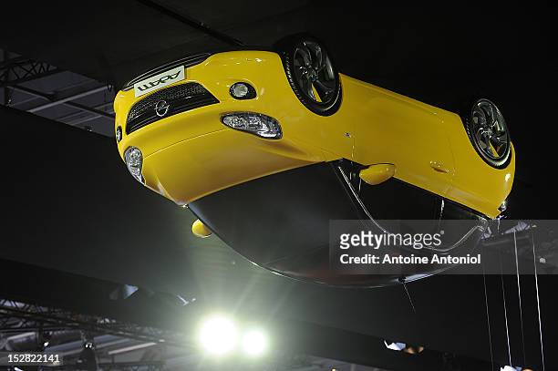 The new Opel Adam car is suspended from the roof of the Paris Auto Show on September 27, 2012 in Paris, France. Opel, which has been owned by General...