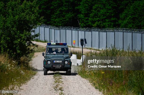 Polish border guard patrols by the metal wall between the Polish Belarusian border on July 09, 2023 in Jurowlany, Poland. Last week, the Polish...