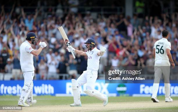 Chris Woakes of England celebrates with teammate Mark Wood after hitting the winning runs to win the LV= Insurance Ashes 3rd Test Match between...