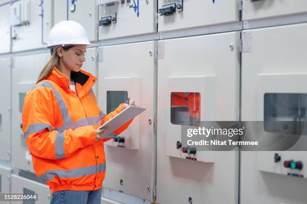 improved switchgear availability and reliability through early detection of impending failure in the power generation industry. a power engineer in front of the switchgear to examine operating that equipment at higher performance levels. - poor quality stock pictures, royalty-free photos & images