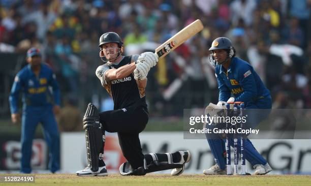Rob Nicol of New Zealand hits out for six runs watched by Sri Lanka wicketkeeper Kumar Sangakkara during the ICC World Twenty20 2012 Super Eights...