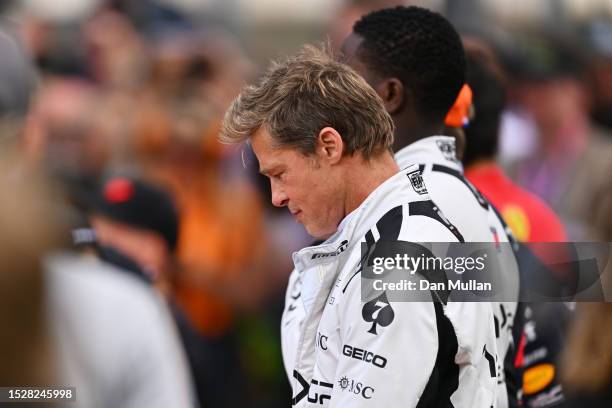 Brad Pitt, star of the upcoming Formula One based movie, Apex, stands for the national anthem on the grid during the F1 Grand Prix of Great Britain...