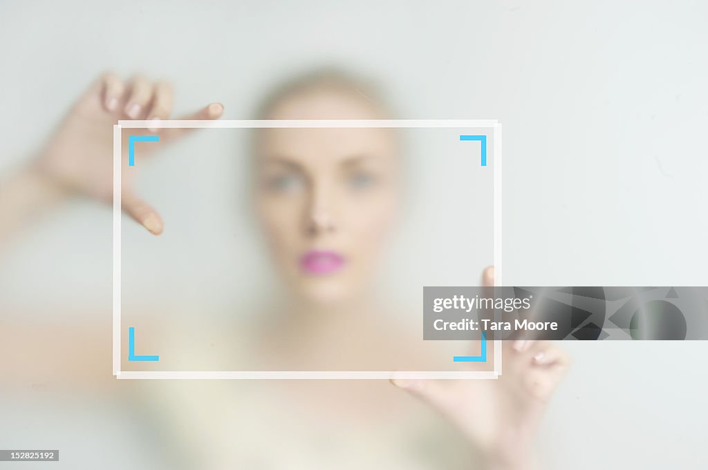 Woman framing picture with hands