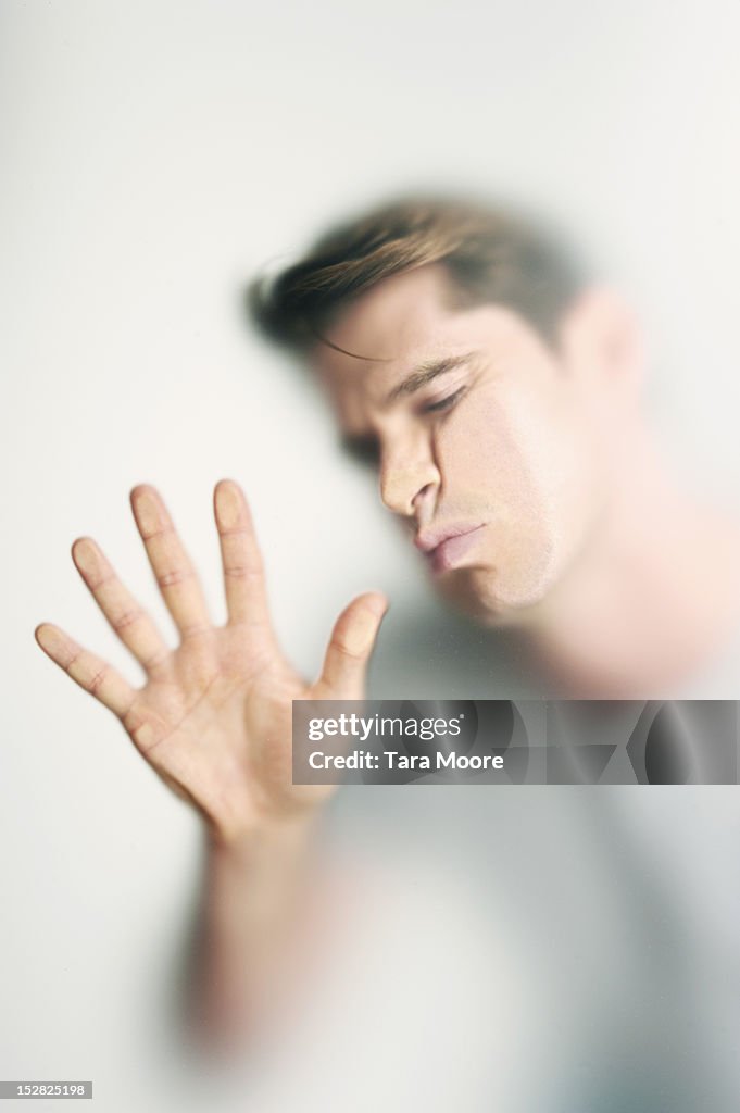 Man with face pressed against glass