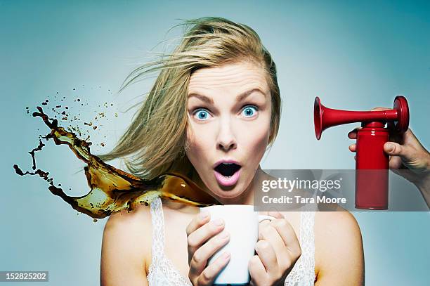 tired woman staying awake with coffee and air horn - spilling stock pictures, royalty-free photos & images