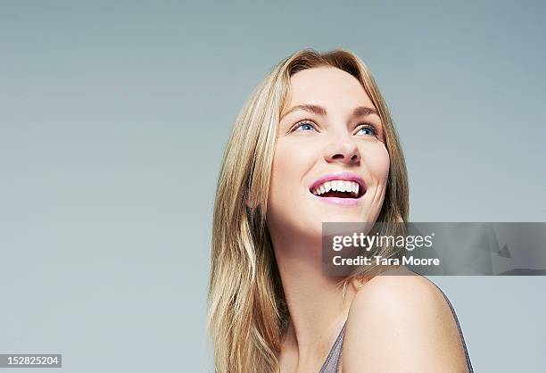 beautiful woman looking up and smiling - female blonde blue eyes stock pictures, royalty-free photos & images