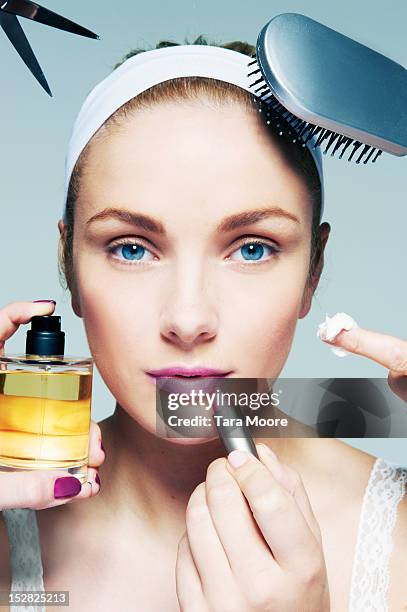 woman applying various beauty products to face - make up brush stock-fotos und bilder