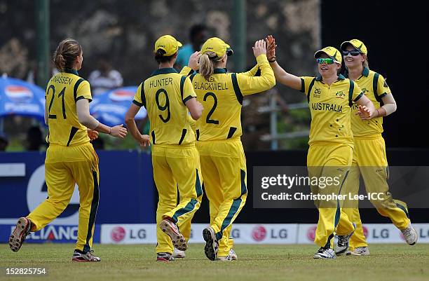 Jess Cameron of Australia is congratulated by her team mates after catching out Jhulan Goswami of India during the ICC Women's World Twenty20 Group A...