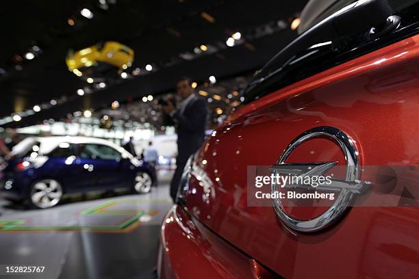 Visitor looks at the Opel Adam automobiles, produced by General Motors Co. , on the first day of the Paris Motor Show in Paris, France, on Thursday,...