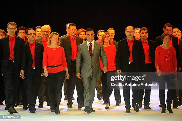Carlos Ghosn, chief executive officer of Nissan Motor Co. And Renault SA, arrives on stage wtih employees for a news conference for the presentation...