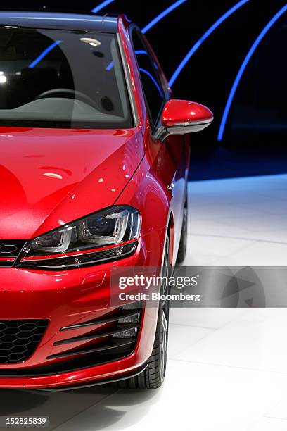 New Volkswagen Golf GTI automobile, produced by Volkswagen AG , sits on display on the first day of the Paris Motor Show in Paris, France, on...
