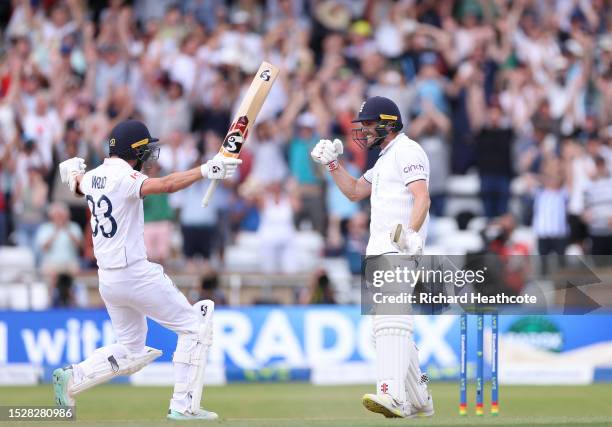 Chris Woakes of England celebrates with teammate Mark Wood after hitting the winning runs to win the LV= Insurance Ashes 3rd Test Match between...