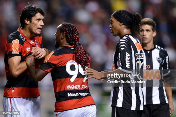 Marcos Gonzalez of Flamengo discusses with Ronaldinho Gaucho of Atletico Mineiro during a match between Flamengo and Atletico Mineiro as part of the...