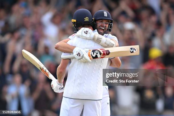 Chris Woakes of England celebrates with teammate Mark Wood after hitting the winning runs to win the LV= Insurance Ashes 3rd Test Match between...