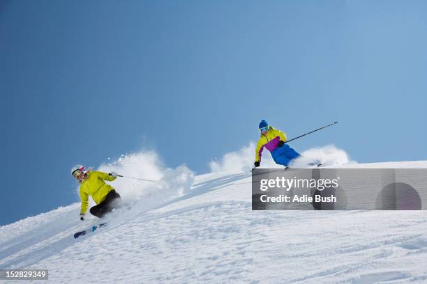 skiers coasting on snowy slope - ski speed stock pictures, royalty-free photos & images