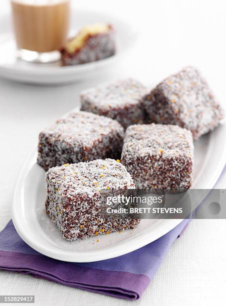 plate of lamingtons cookies - lamington cake stock pictures, royalty-free photos & images