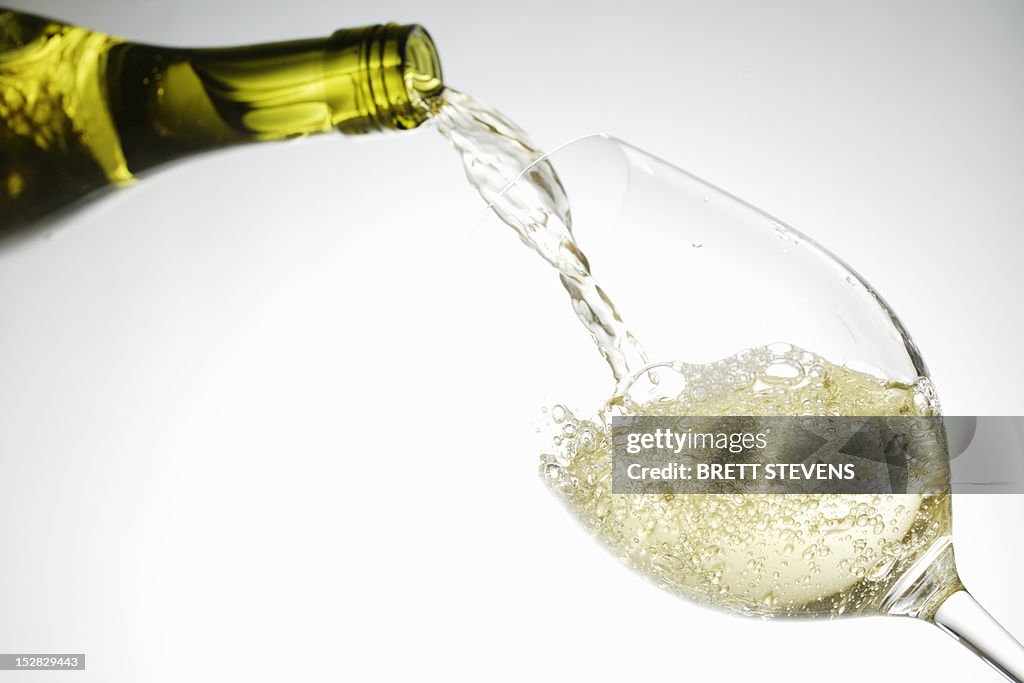 White wine pouring into glass