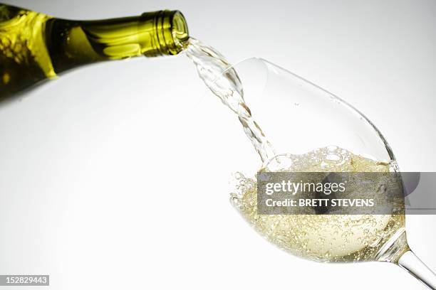 white wine pouring into glass - white wine glass bildbanksfoton och bilder