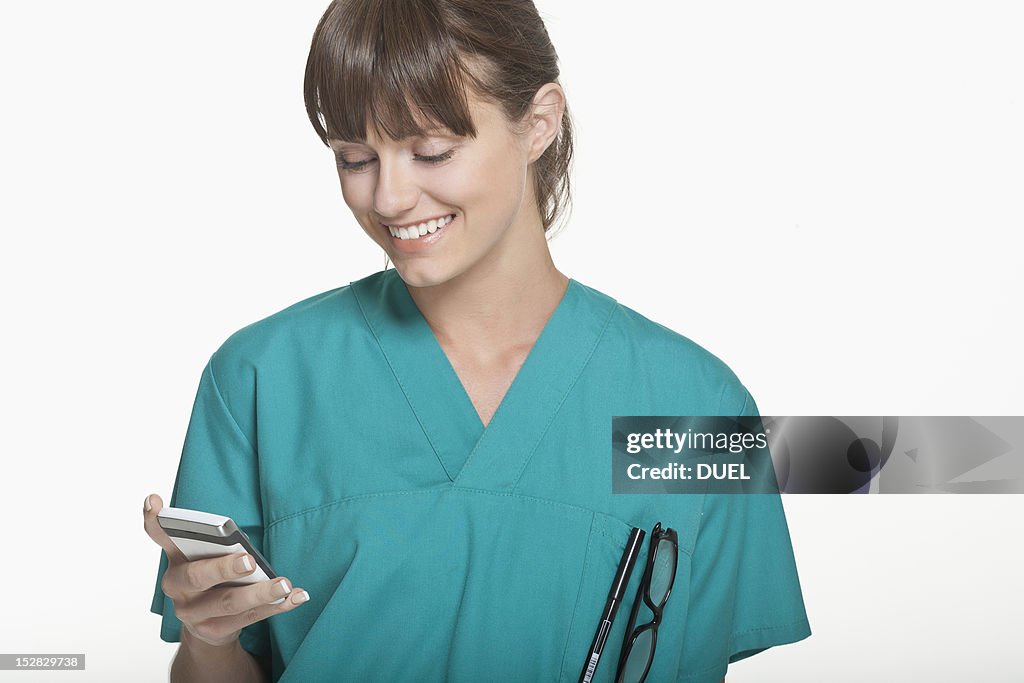 Smiling surgeon using cell phone