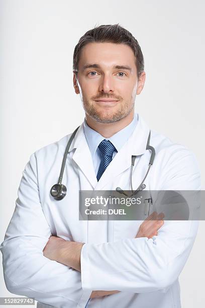 doctor standing with crossed arms - doctor with arms crossed stock pictures, royalty-free photos & images