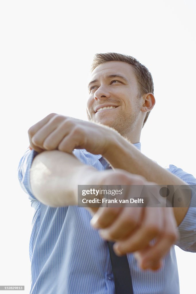 Businessman rolling up sleeves