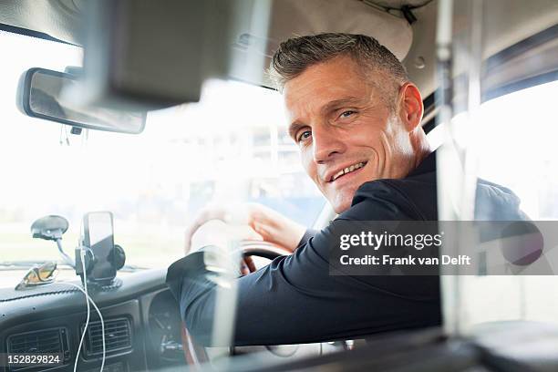 taxi driver sitting at steering wheel - car turning stock pictures, royalty-free photos & images