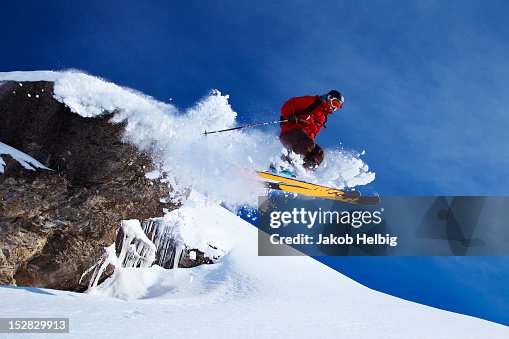 Skier jumping on snowy slope Skier jumping on snowy slope