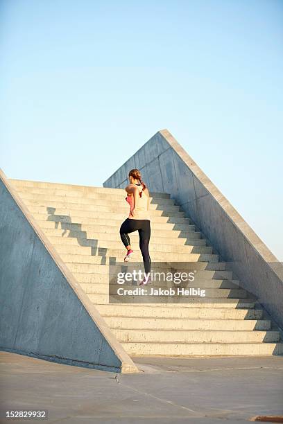 woman running on staircase - stairway heaven stock pictures, royalty-free photos & images