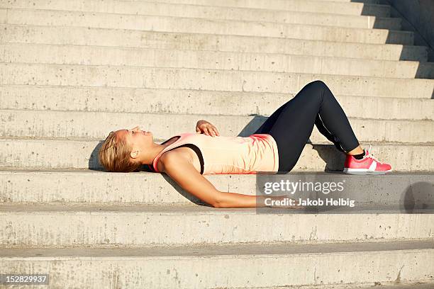 runner resting on staircase - runner resting stock pictures, royalty-free photos & images