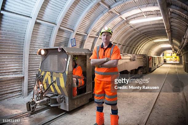 portrait of miner in transport tunnel of deep coalmine - miner portrait stock pictures, royalty-free photos & images