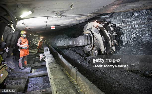 miners cutting coal at coal seem in deep mine - mijnwerker stockfoto's en -beelden