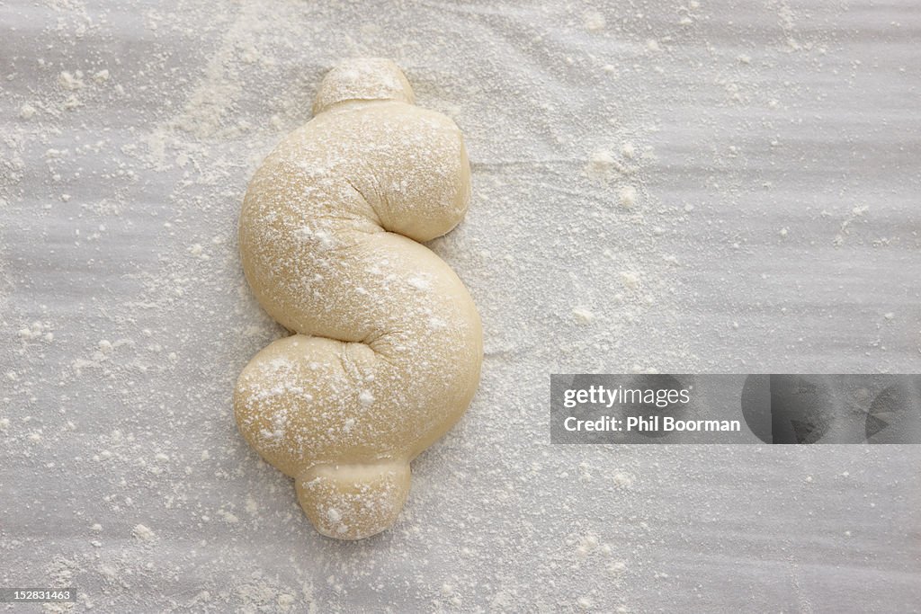 Bread dough shaped in dollar sign