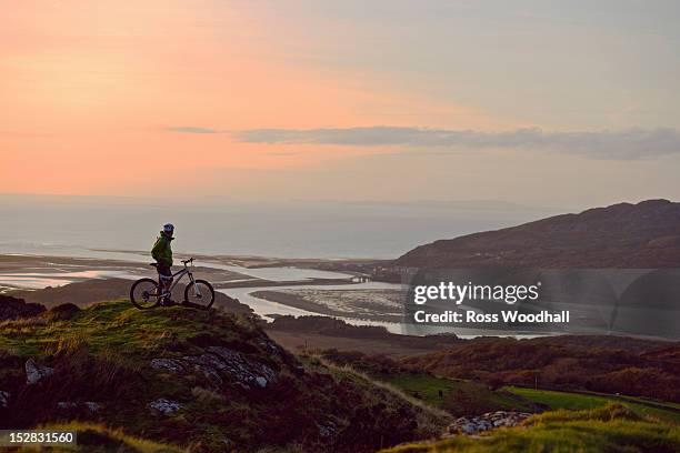 mountain biker standing on hilltop - mountain biking uk stock pictures, royalty-free photos & images