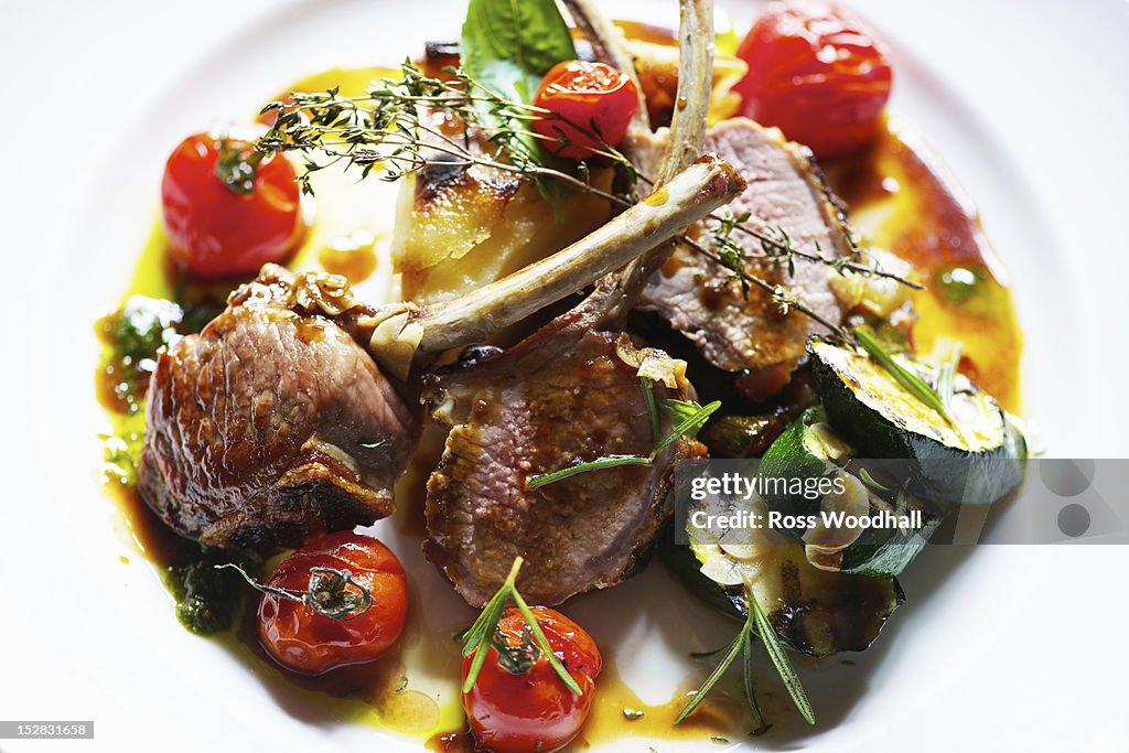 Plate of lamb cutlets with tomatoes
