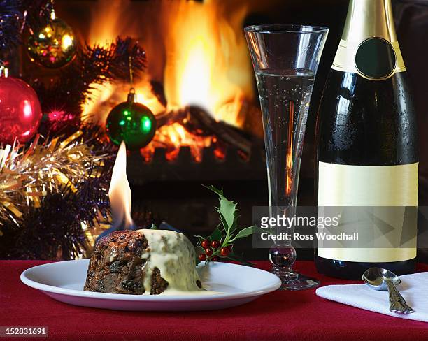 plate of flaming christmas pudding - christmas dessert stock pictures, royalty-free photos & images