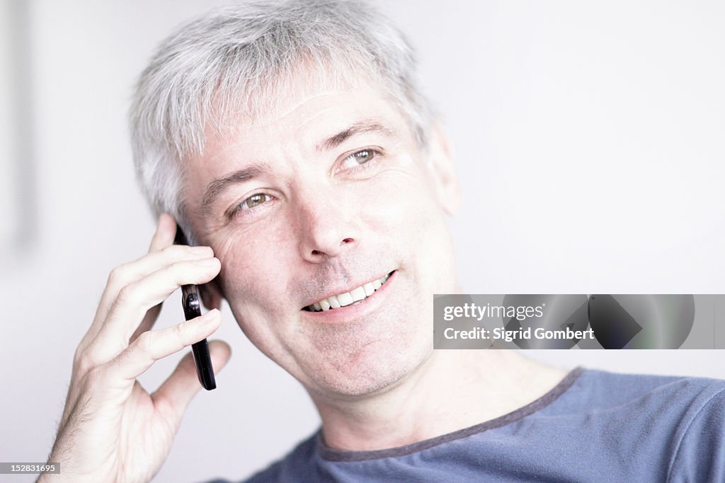 Smiling man talking on cell phone