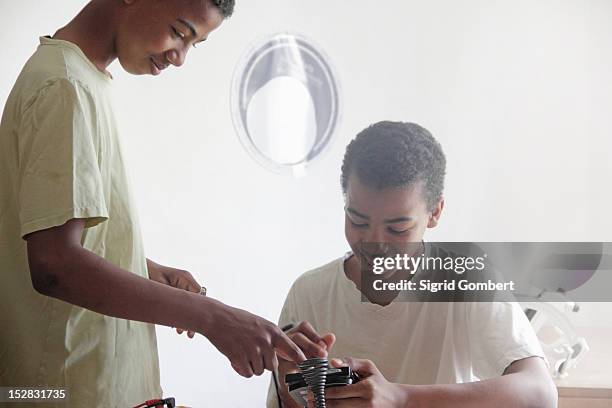 students working in science lab - twin boys stock pictures, royalty-free photos & images