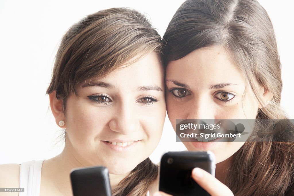 Teenage girls using cell phones