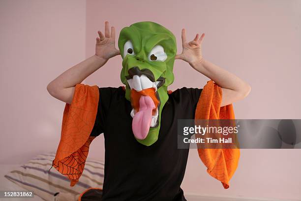 child grimacing in halloween costume - child mask stock pictures, royalty-free photos & images