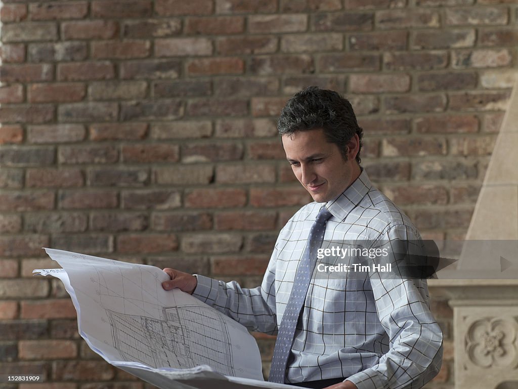 Businessman reading blueprints