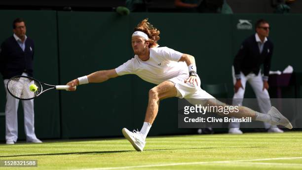 Andrey Rublev stretches to play a forehand against Alexander Bublik of Kazakhstan in the Men's Singles fourth round match during day seven of The...