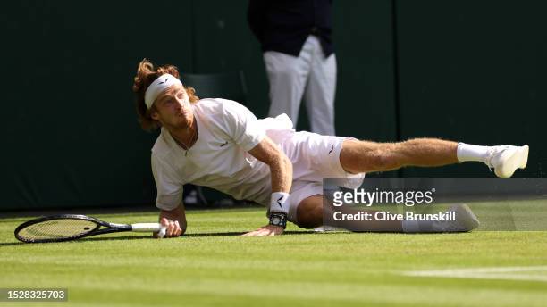 Andrey Rublev stretches to play a forehand against Alexander Bublik of Kazakhstan in the Men's Singles fourth round match during day seven of The...